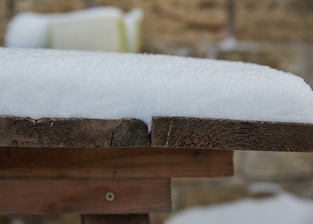 white snow on a wooden table, close upの写真素材