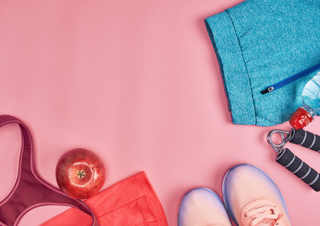 sport textile shoes and other items for fitness on a pink background, top viewの写真素材