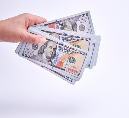 hand holding paper money on a white background, close up
