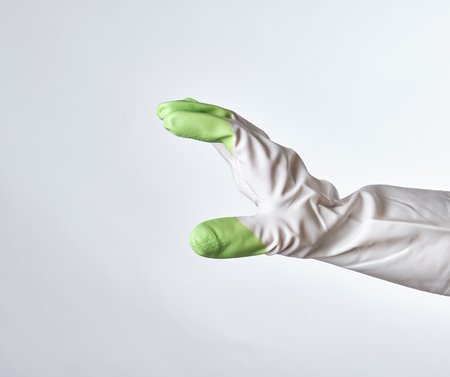 hand in a white-green rubber glove on a white backgroundの写真素材