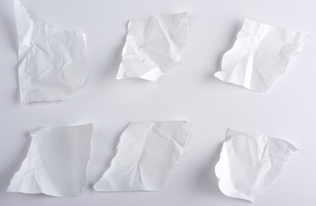 crumpled empty torn pieces of white paper on a white background, top viewの写真素材