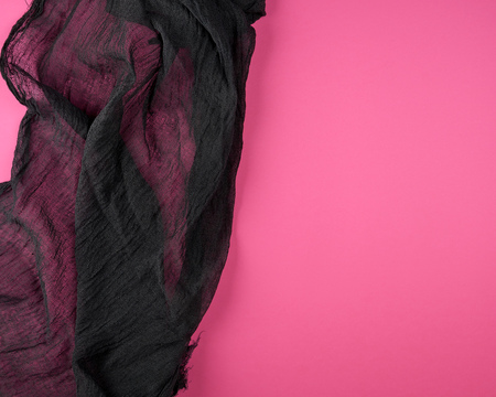 Black textile gauze on a pink background, copy spaceの写真素材