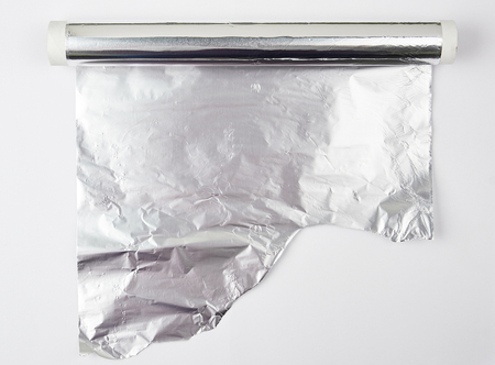 Roll of gray foil for baking and packaging food on a white background, torn edgeの写真素材