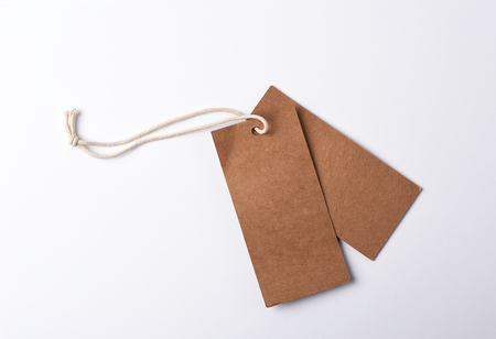 Empty paper brown tag on the rope, white background, close upの写真素材