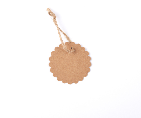 Empty paper round brown tag on a rope, white background, sales conceptの写真素材