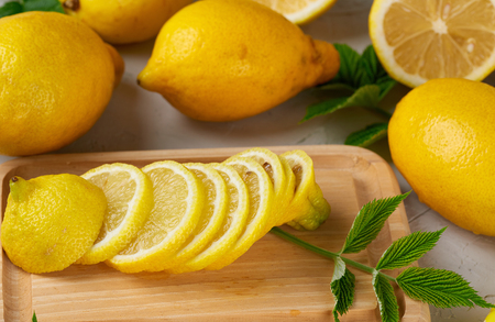 fresh whole yellow lemons and sliced fruits, ingredients for making summer drinks, top viewの写真素材