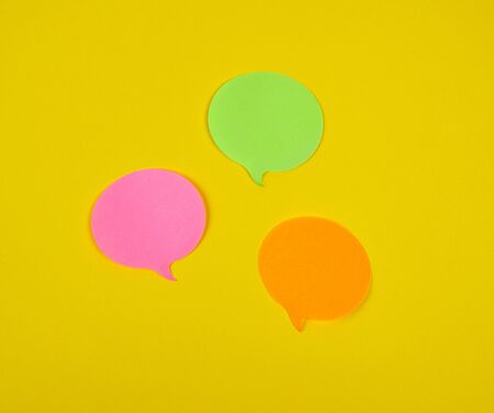 paper sticky cloud-shaped stickers on a yellow background, close up