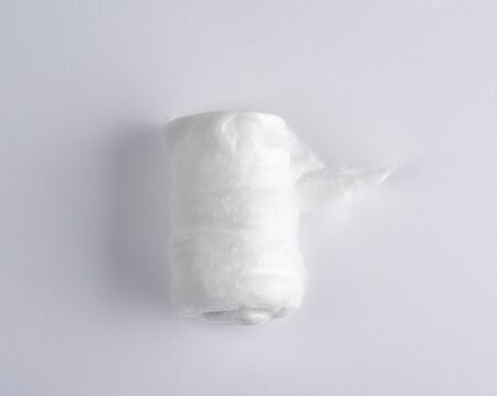 white medical cotton twisted into a roll on a white background, top viewの写真素材