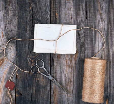 tied up with a rope a stack of empty cards on a gray wooden table, top view