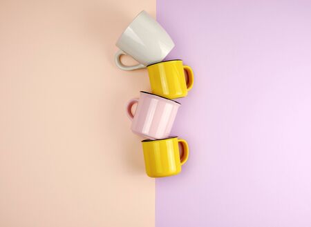 multi-colored ceramic cups with a handle on an abstract pastel background, flat layの写真素材