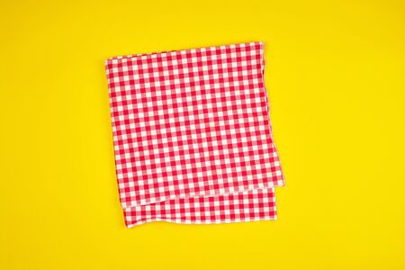 white red checkered kitchen towel on a yellow background, bright picnic background, copy spaceの写真素材