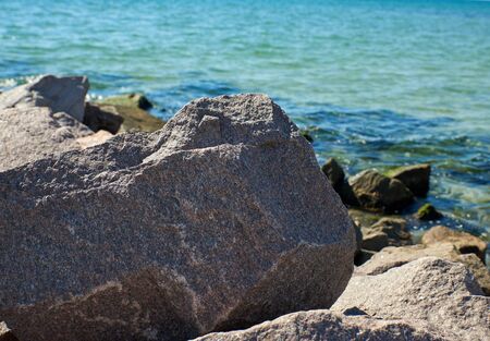 stone sticking out of the sea water summer day, close up, Ukraineの写真素材