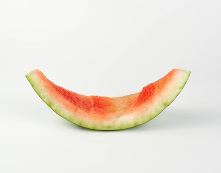 stub of red ripe round watermelon on a white background, close up