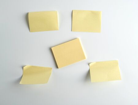Yellow paper stickers on white background, close up