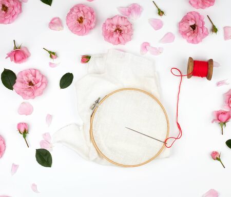 round wooden hoop and a red thread with a needle, concept of embroidery products, top viewの写真素材