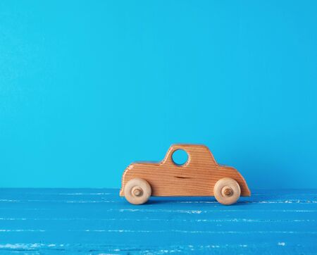 vintage wooden children's car on a blue background, copy spaceの写真素材