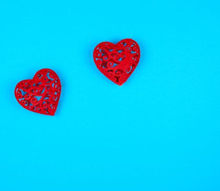 two red decorative hearts on a blue  background, copy spaceの写真素材