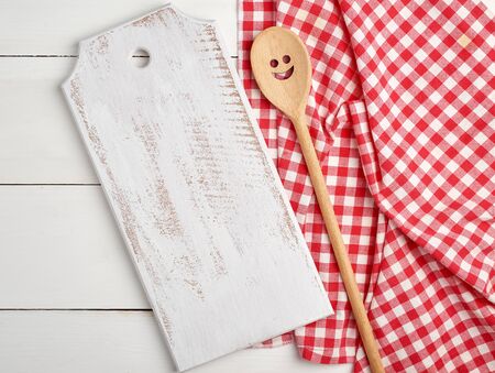 rectangular empty wooden cutting boards and red towel, white tableの写真素材