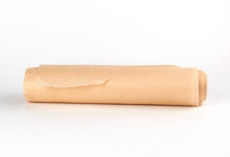 twisted bundle of brown parchment baking paper on a white background,close upの写真素材