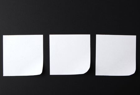 empty white sheet of paper on a black background, copy spaceの写真素材
