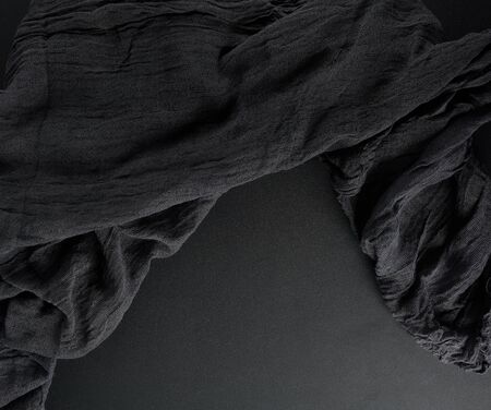 crumpled black gauze fabric on a black background, copys pace, top viewの写真素材