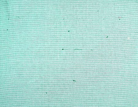 wrong side with a stitch of green thread of fabric with embroidery with multi-colored sequins, full...