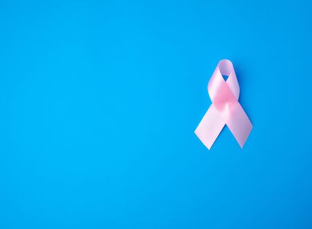 pink ribbon on a blue background, breast cancer awareness symbol, copy spaceの写真素材