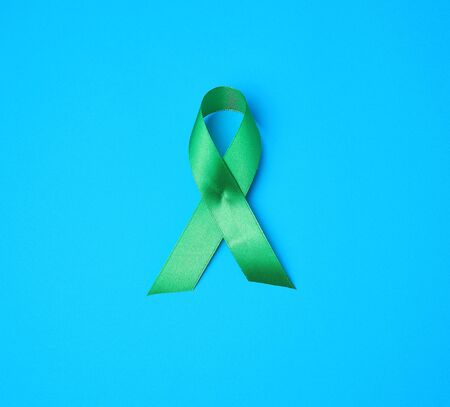 green ribbon as a symbol of early research and disease control, symbol of Lyme disease, kidney transplantation and organ donationの写真素材