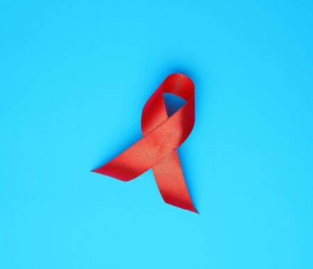 red ribbon-symbol of the fight against disease AIDS and vasculitis, close upの写真素材
