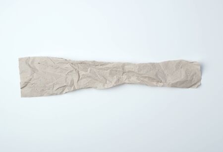 crumpled torn piece of gray paper on a white background, close up