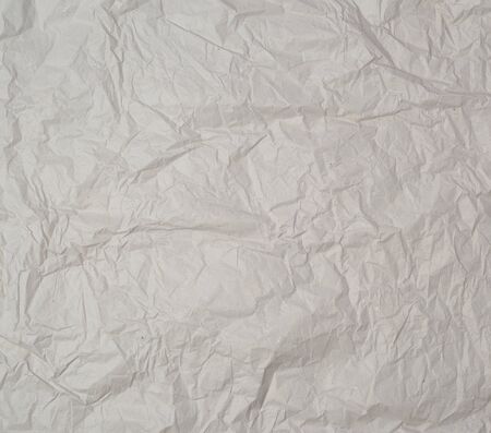 empty gray crumpled sheet of paper, full frame, close upの写真素材