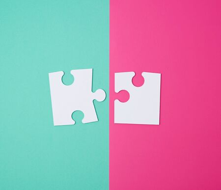 white large blank puzzles on a pink green background, top view, copy spaceの写真素材