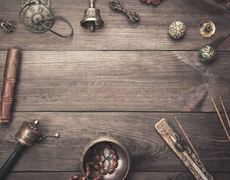 Copper singing bowl, prayer beads, prayer drum and other Tibetan religious objects for meditation...