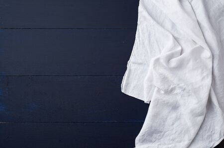 white linen towel on blue wooden background, top view, copy spaceの写真素材