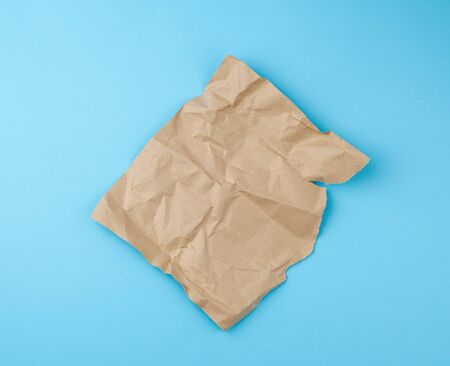 sheet of brown craft paper for packaging on a blue background, close up