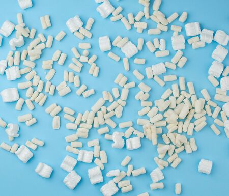 scattered white foam for packaging parcels on a blue background, full frameの写真素材