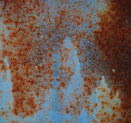 brown iron texture of rusty sheet with remains of blue paint. Metal rusty texture background rust...