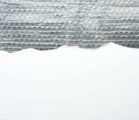fragment of a transparent film with air for transportation of parcels is glued on gray polyethylene, inside of the envelopeの写真素材