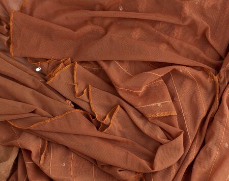 crumpled brown tulle, fabric for sewing clothes, full frame, close upの写真素材