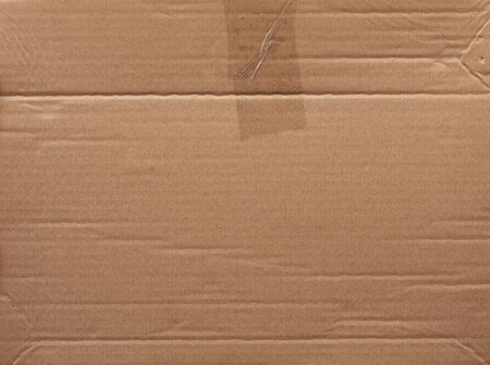 piece of smooth brown cardboard paper, full frame, close up
