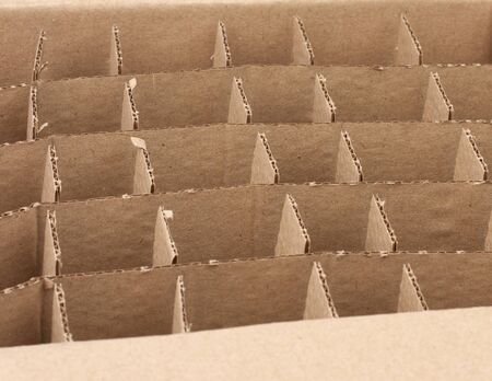 open empty cardboard box with partitions for transporting broken items of bottles and cans, close up