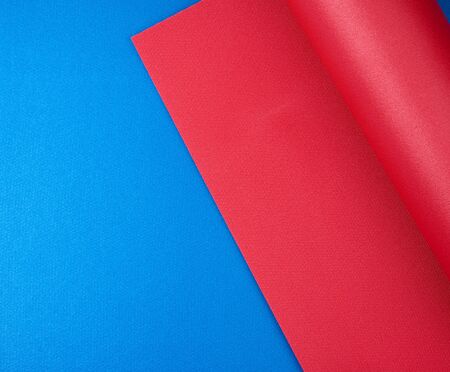 neoprene red twisted mat lies on a blue rug, sports equipment, copy space