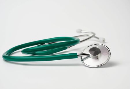 green medical stethoscope on white background, medical item for measurementの写真素材