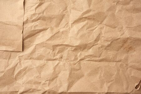 crumpled blank sheet of brown wrapping kraft paper, vintage texture for the designer, full frameの写真素材