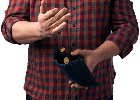 man in a red shirt pours hryvnia coins from a brown leather wallet into his hand, poverty conceptの写真素材