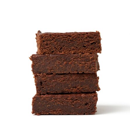 stack of square baked pieces of brownie chocolate cake isolated on a white background, delicious dessert, element for the designerの写真素材