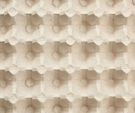 volumetric texture of a beige paper egg tray, full frame, close up