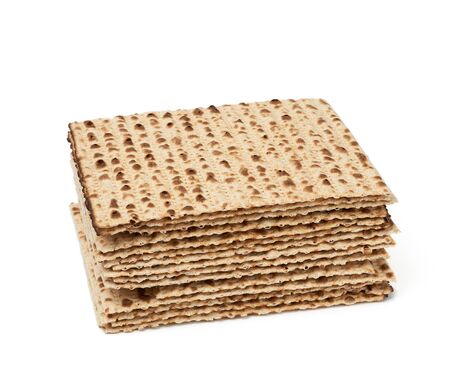 stack of baked matzoh isolated on a white background. Pesah celebration concept, jewish Passover...