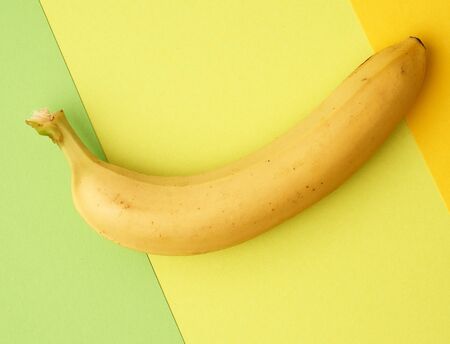 ripe yellow banana on a colored background, top view, close upの写真素材