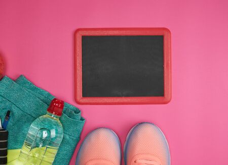 empty frame and objects and clothes for sports and fitness on a pink background, copy spaceの写真素材